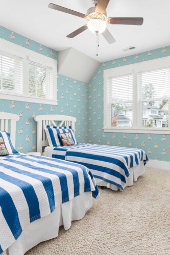 Fancy Walls peel and stick wallpaper featuring sweet yellow ducks on soft blue for a playful nursery look.