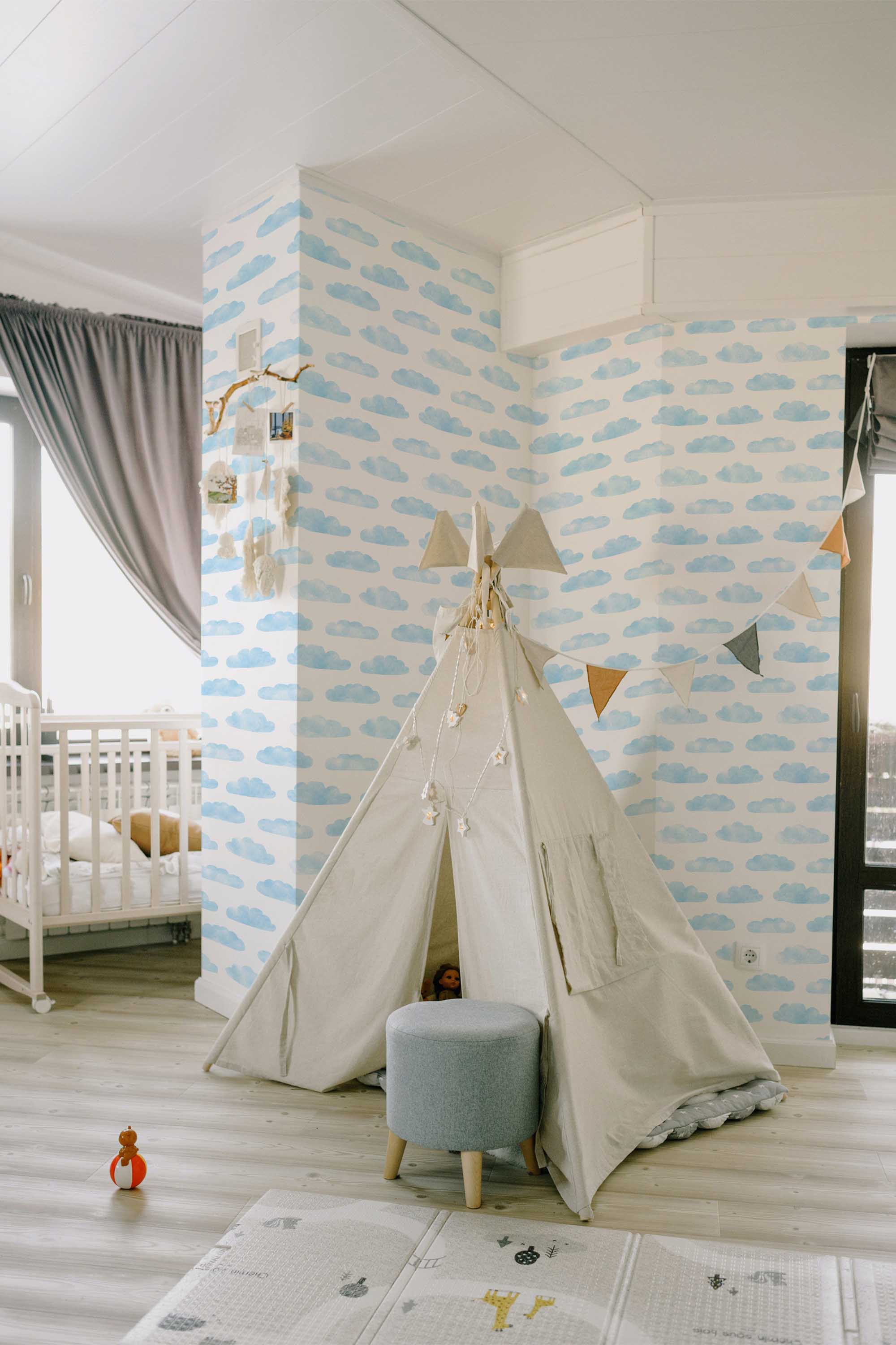 Fancy Walls self-adhesive wallpaper with hand-painted blue and white clouds ideal for creating a peaceful airy room atmosphere.