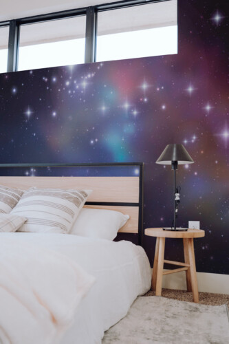 Cosmic Starfield wall mural peel and stick design by Fancy Walls showcasing luminous galaxies and a soft celestial glow.