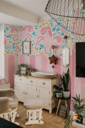 Unicorn Garden peel and stick wall mural with pink unicorns and floral décor for dreamy nursery spaces.