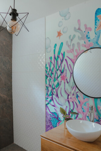 Fancy Walls Watercolor Coral Garden peel and stick wall mural featuring soft pink, blue, and violet coral tones.