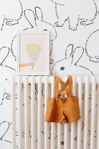 Fancy Walls peel and stick wallpaper featuring oversized fluffy bunny line art in blue and white for a soft minimalist nursery look.