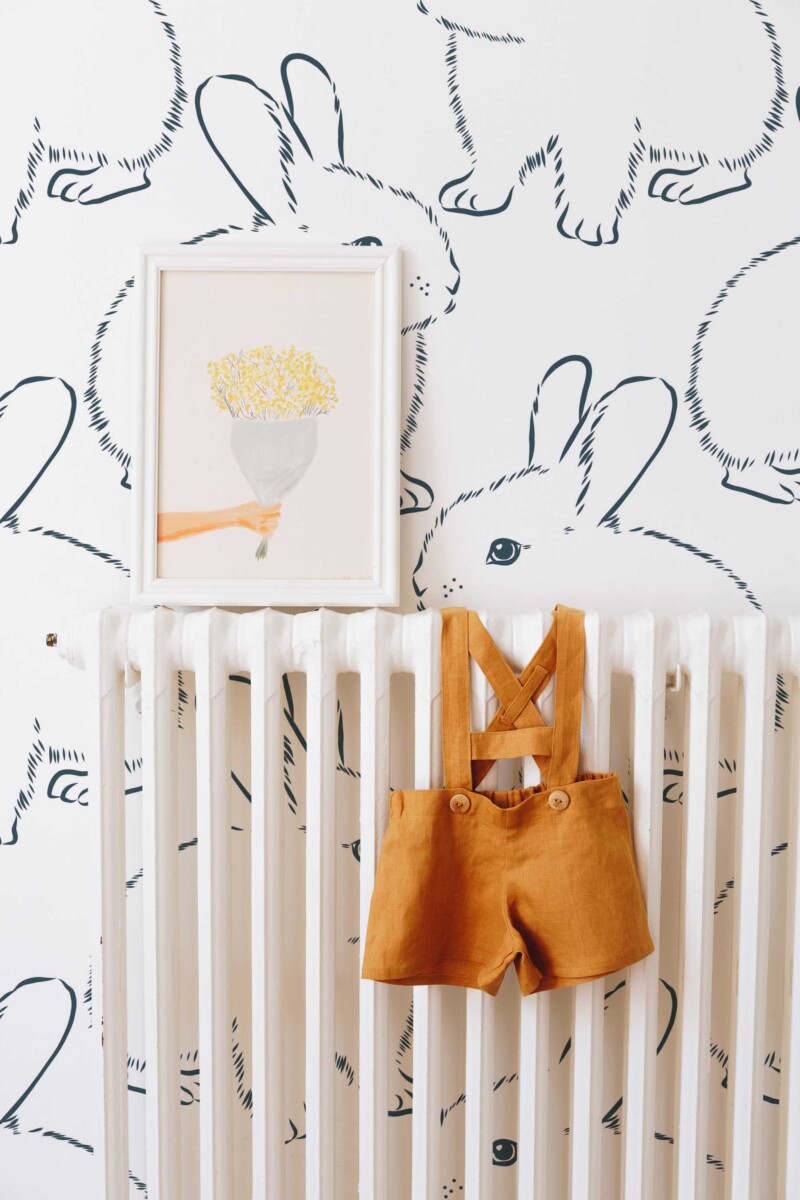 Fancy Walls peel and stick wallpaper featuring oversized fluffy bunny line art in blue and white for a soft minimalist nursery look.