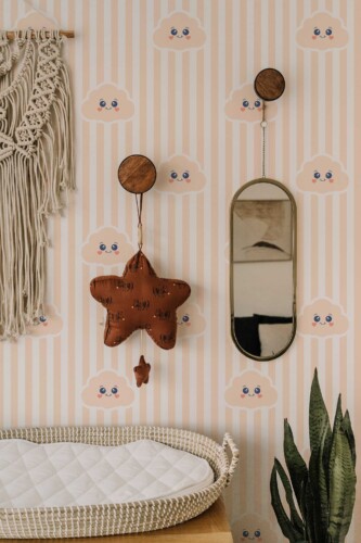 Fancy Walls peel and stick wallpaper with smiling peach clouds and neutral stripes for a soft minimal nursery style.