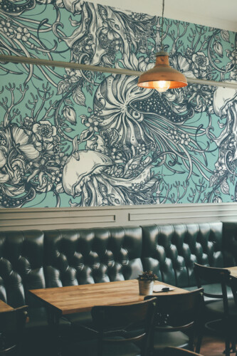 Fancy Walls Vintage Ocean Reverie peel and stick wall mural featuring artistic sea life on a teal background.