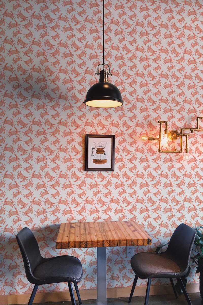 Fancy Walls peel and stick wallpaper with cute rust crayfish on a light beige background for a playful nautical interior.