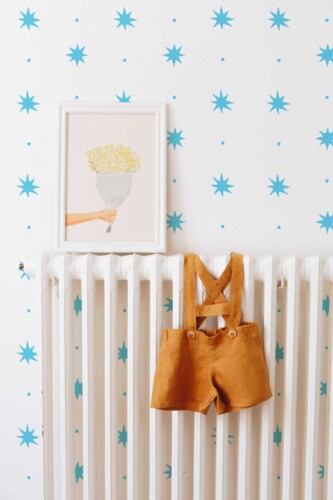 Fancy Walls playful blue and white dots and stars peel and stick wallpaper for light modern interiors.