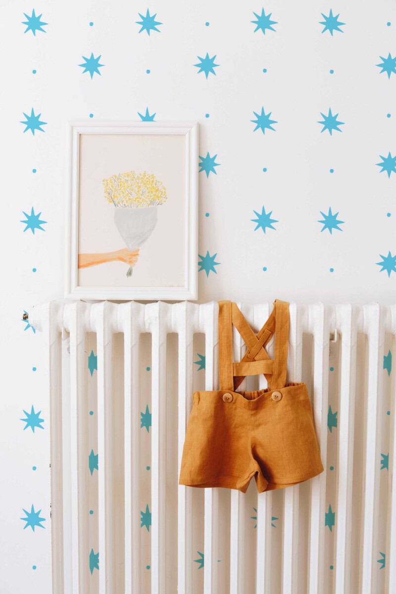 Fancy Walls playful blue and white dots and stars peel and stick wallpaper for light modern interiors.