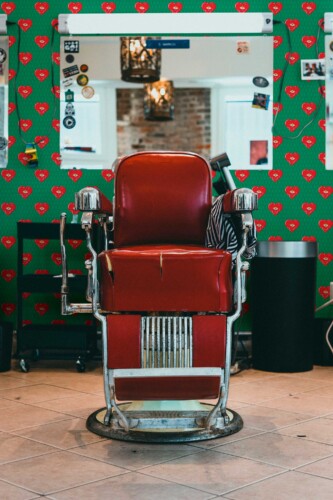 Fancy Walls peel and stick wallpaper with red pop art hearts and quirky eyes on a bright green background.