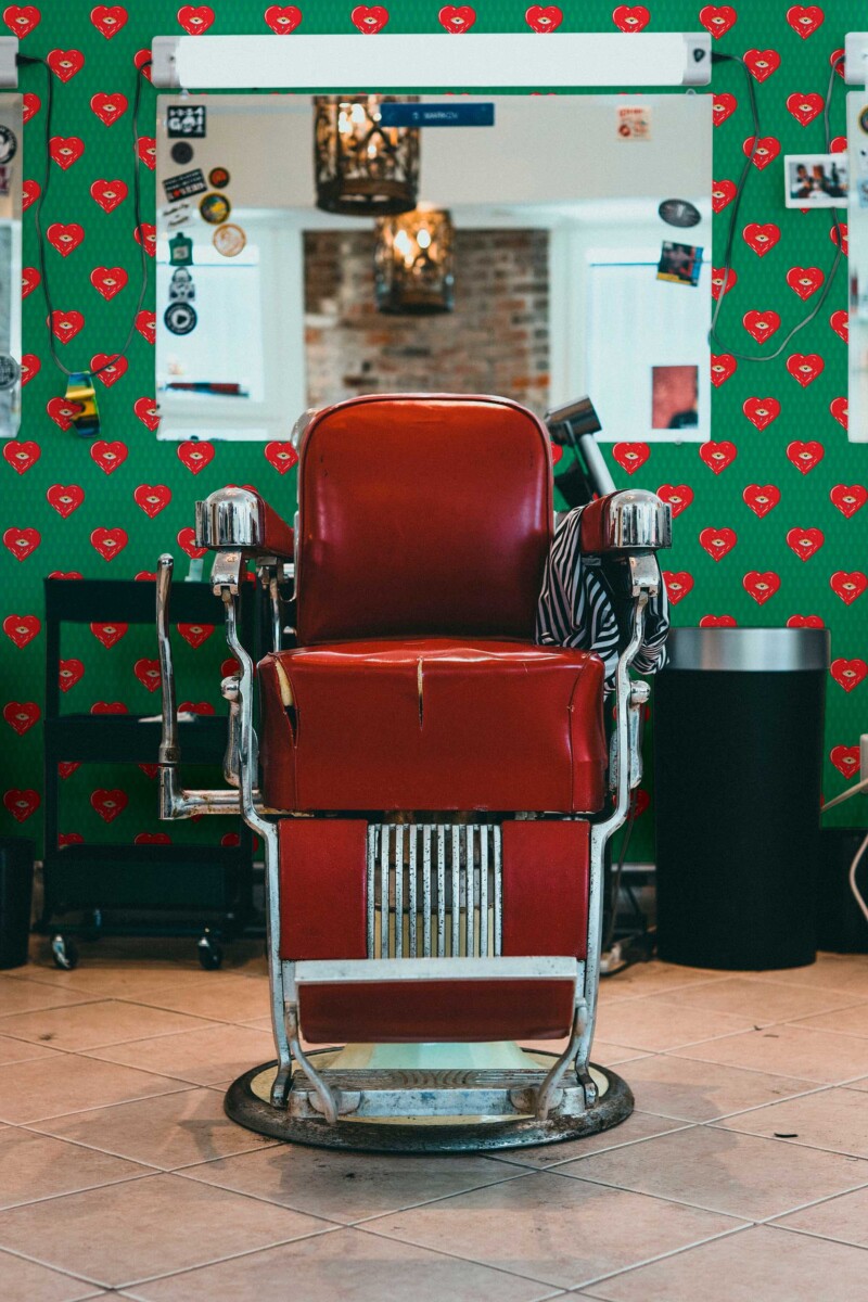 Fancy Walls peel and stick wallpaper with red pop art hearts and quirky eyes on a bright green background.