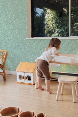 Fancy Walls peel and stick wallpaper with mint green star pattern creating a soft and playful boho interior mood.