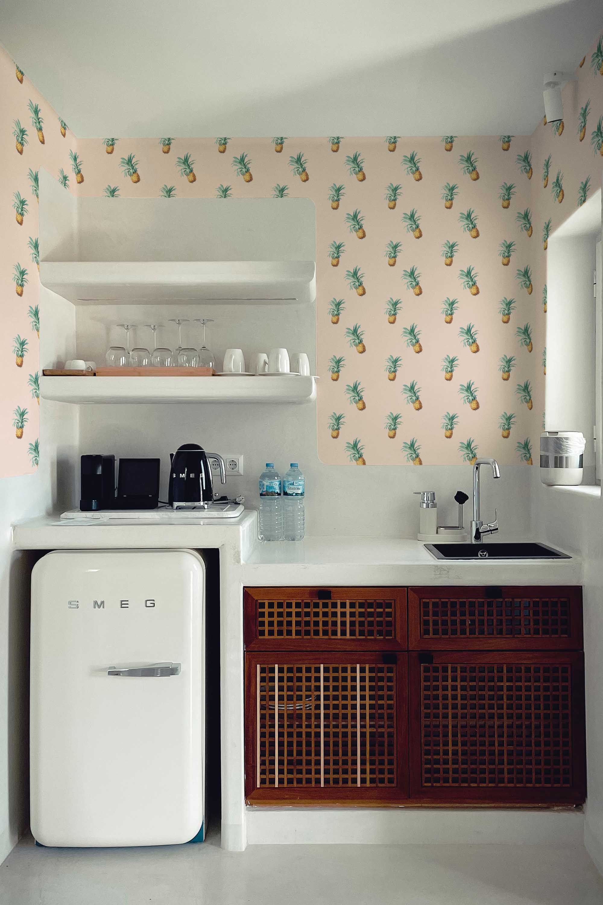 Fancy Walls self-adhesive wallpaper featuring charming pineapples with green leaves on a soft beige background.