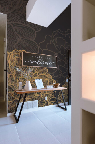 Fancy Walls peel and stick eco-friendly wall mural with gold peony line art on dark background for glam bedrooms and art deco interiors. Luxury floral wallpaper mural.