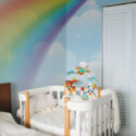 Fancy Walls peel and stick wall mural with pastel rainbow and soft clouds for dreamy nursery and kids room décor in modern Scandinavian style.