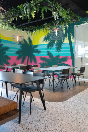 Fancy Walls peel and stick PVC-free wall mural with dark blue palm silhouettes on colorful abstract beach background for vibrant game rooms and creative interiors.