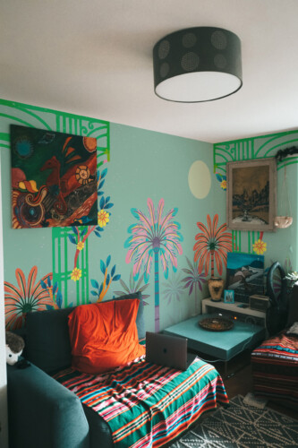 Fancy Walls peel and stick PVC-free wall mural with vibrant tropical palms and art deco columns for eclectic living rooms and creative interiors.