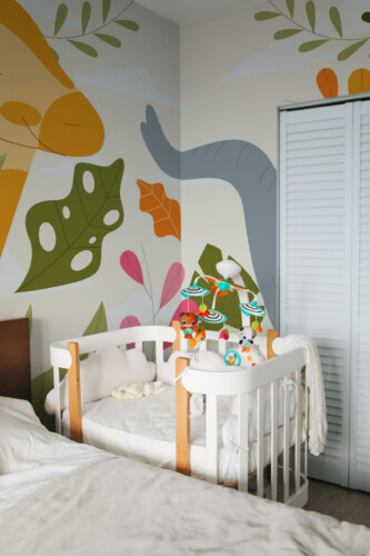 Fancy Walls peel and stick PVC-free wall mural with cute giraffe and elephant jungle leaves for nursery walls, kids rooms, and calm bedrooms in modern playful style.