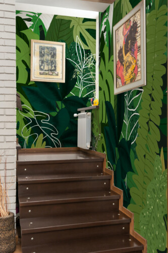 Fancy Walls peel and stick PVC-free wall mural with layered tropical leaves and deep green jungle foliage for living rooms and modern biophilic interiors.