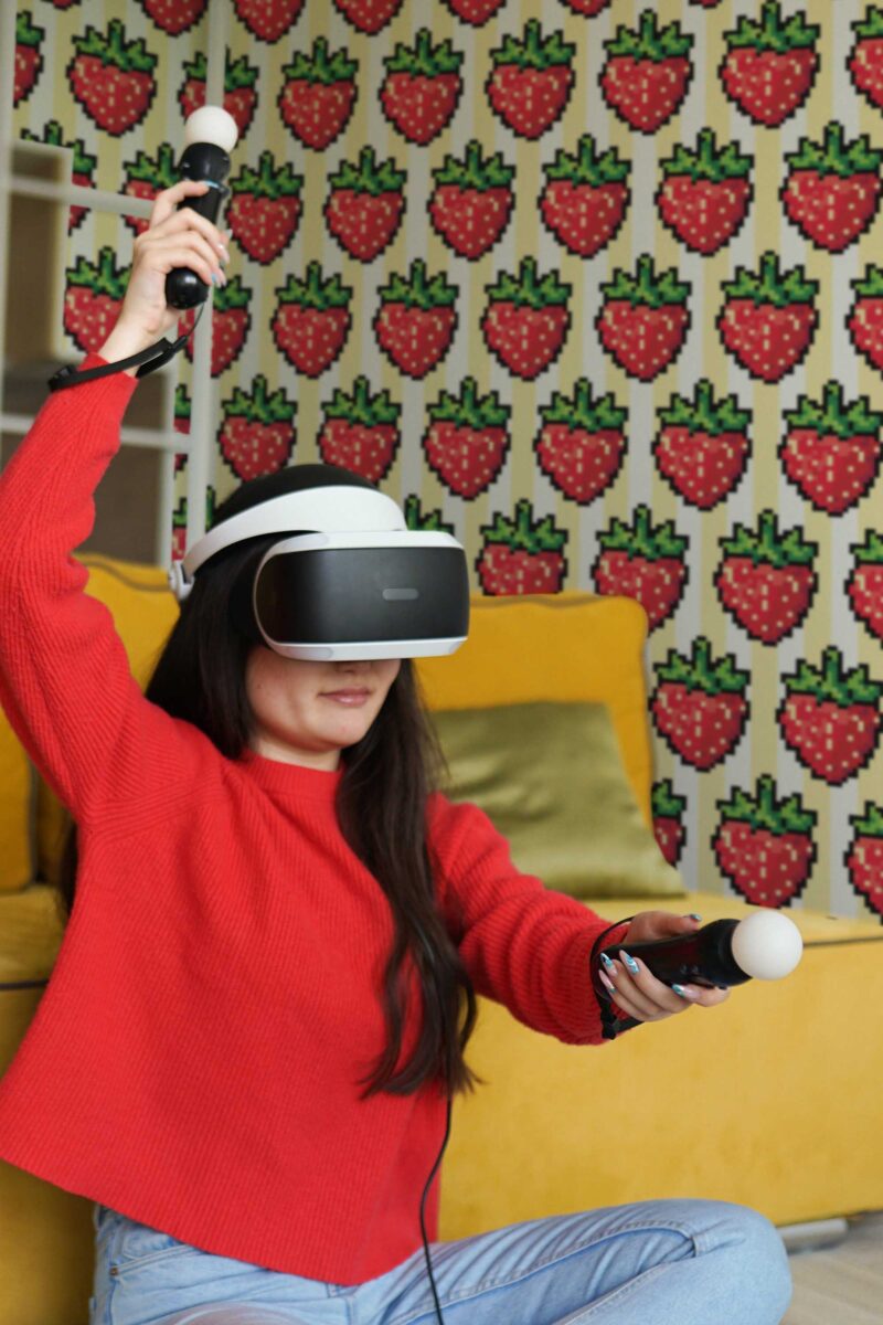 Woman playing video games while wearing a VR headset.