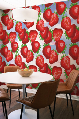 Fancy Walls peel and stick PVC-free wall mural with bright strawberry pattern on soft sky background for playful kids rooms and colorful interiors.