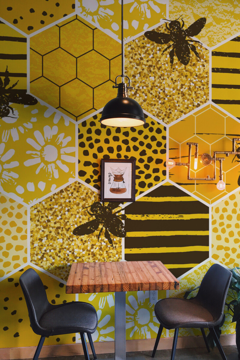 Sunny Honeycomb Meadow removable wall mural with golden hexagon pattern and playful bees, perfect for kitchen décor and warm boho interiors