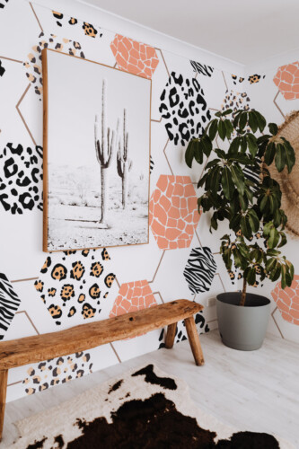 Wild Safari Hexagon removable wall mural with honeycomb pattern and animal prints, creating stylish safari décor for contemporary living room spaces