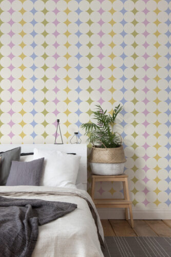 Colorful Retro Polka Dot non-pasted wallpaper covering a bedroom accent wall with large white circles over pastel shapes.