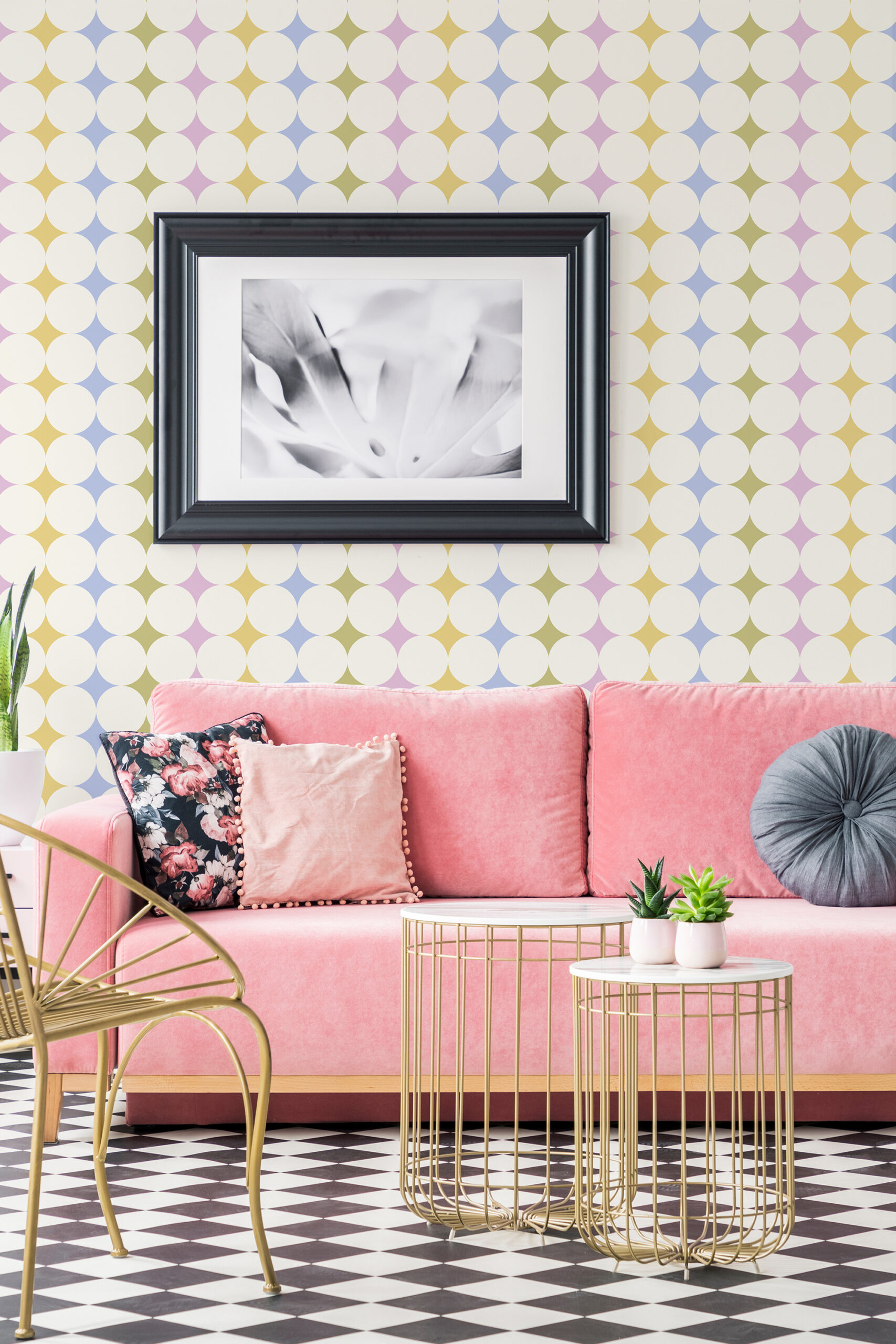 Colorful Retro Polka Dot self-adhesive wallpaper in a living room setting behind a pink sofa and framed wall art.