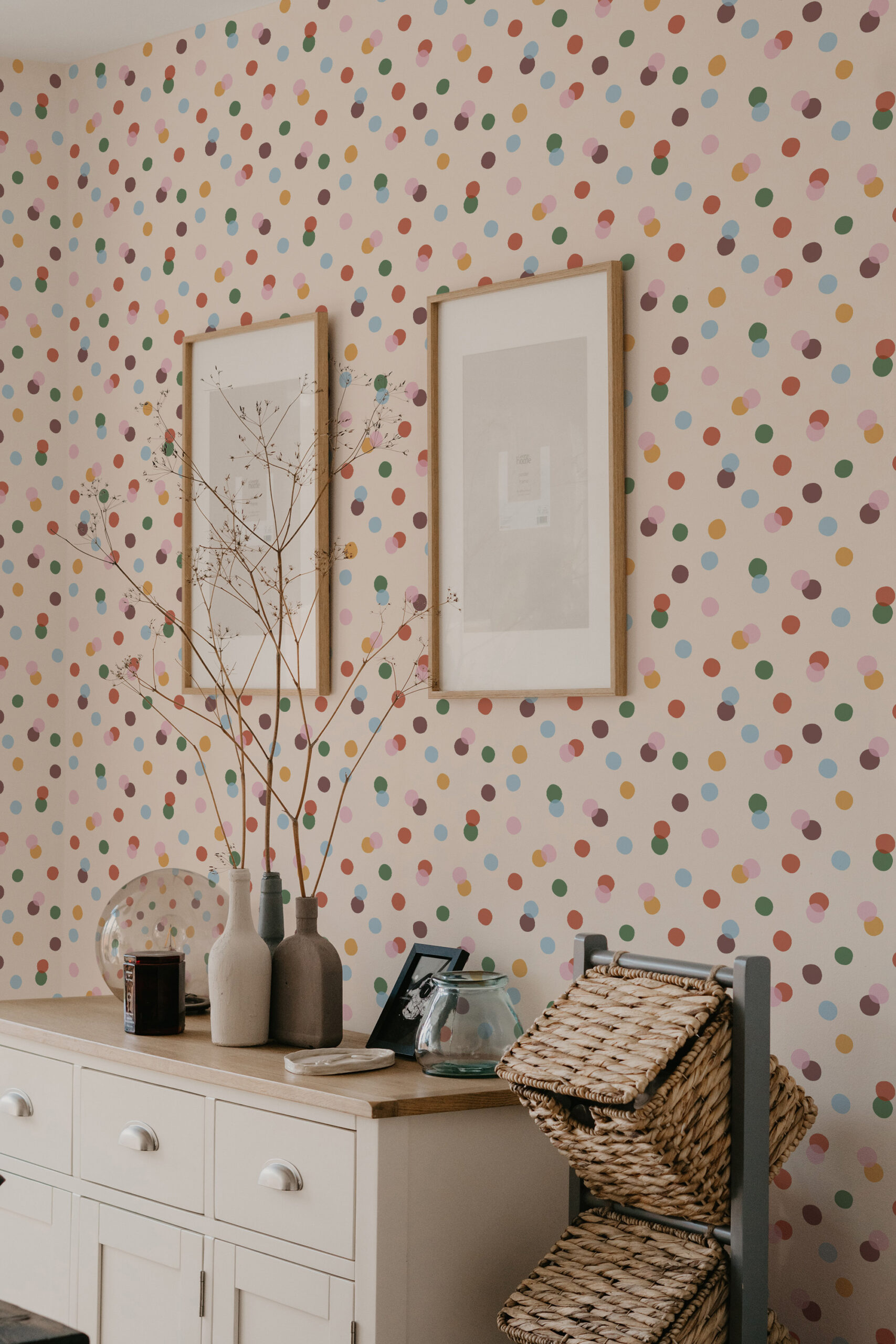 Vintage Colorful Polka Dot non-pasted wallpaper with scattered multicolor dots behind two framed prints above a cabinet.