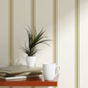 Fine Beige Striped peel and stick wallpaper with thin olive and ochre vertical lines behind a small shelf.