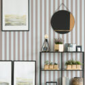 Taupe Blue Vintage Stripe removable wallpaper with wide vertical taupe and pale blue stripes behind a shelving unit.