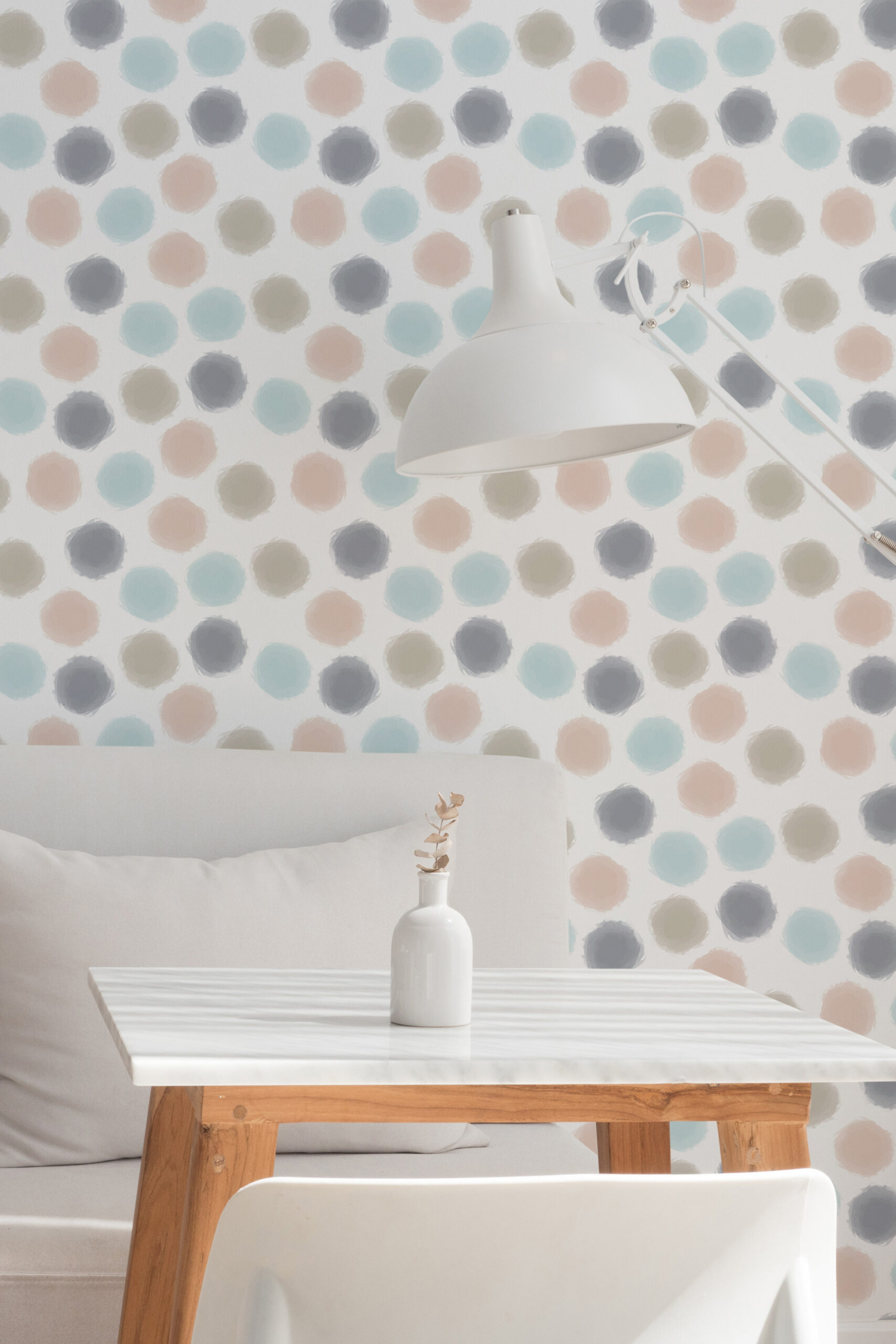Spaced Beige Dots non-pasted wallpaper with pastel painted polka dots on an accent wall behind a desk lamp.