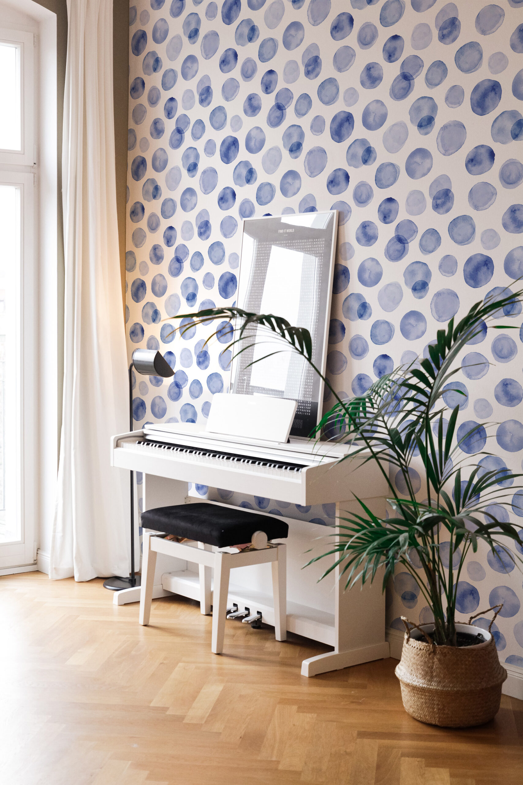 Soft Blue Dots pre-pasted wallpaper on a full wall, with watercolor-style blue circles behind a white piano.