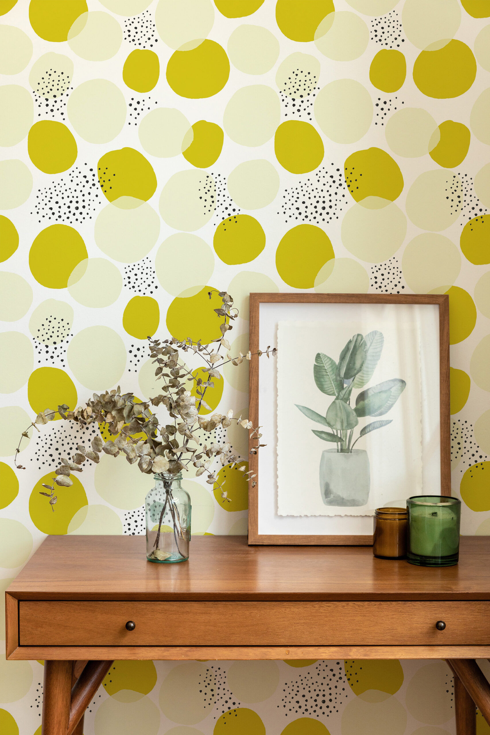 Bold Chartreuse Polka Dot non-pasted wallpaper with oversized chartreuse and pale dots, behind a console table.