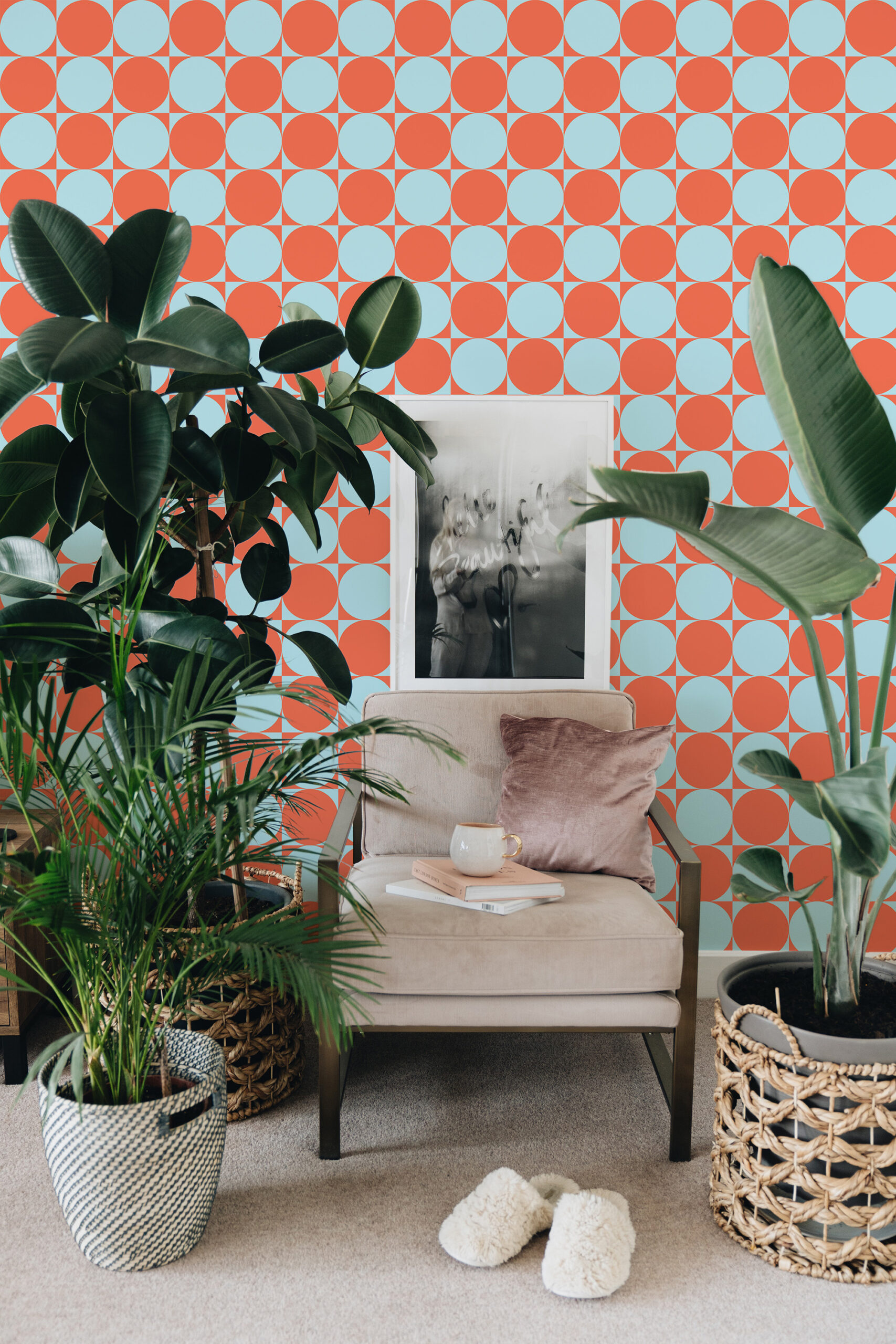 Orange Blue Retro Circles peel and stick wallpaper with alternating orange and light blue circles behind an armchair.