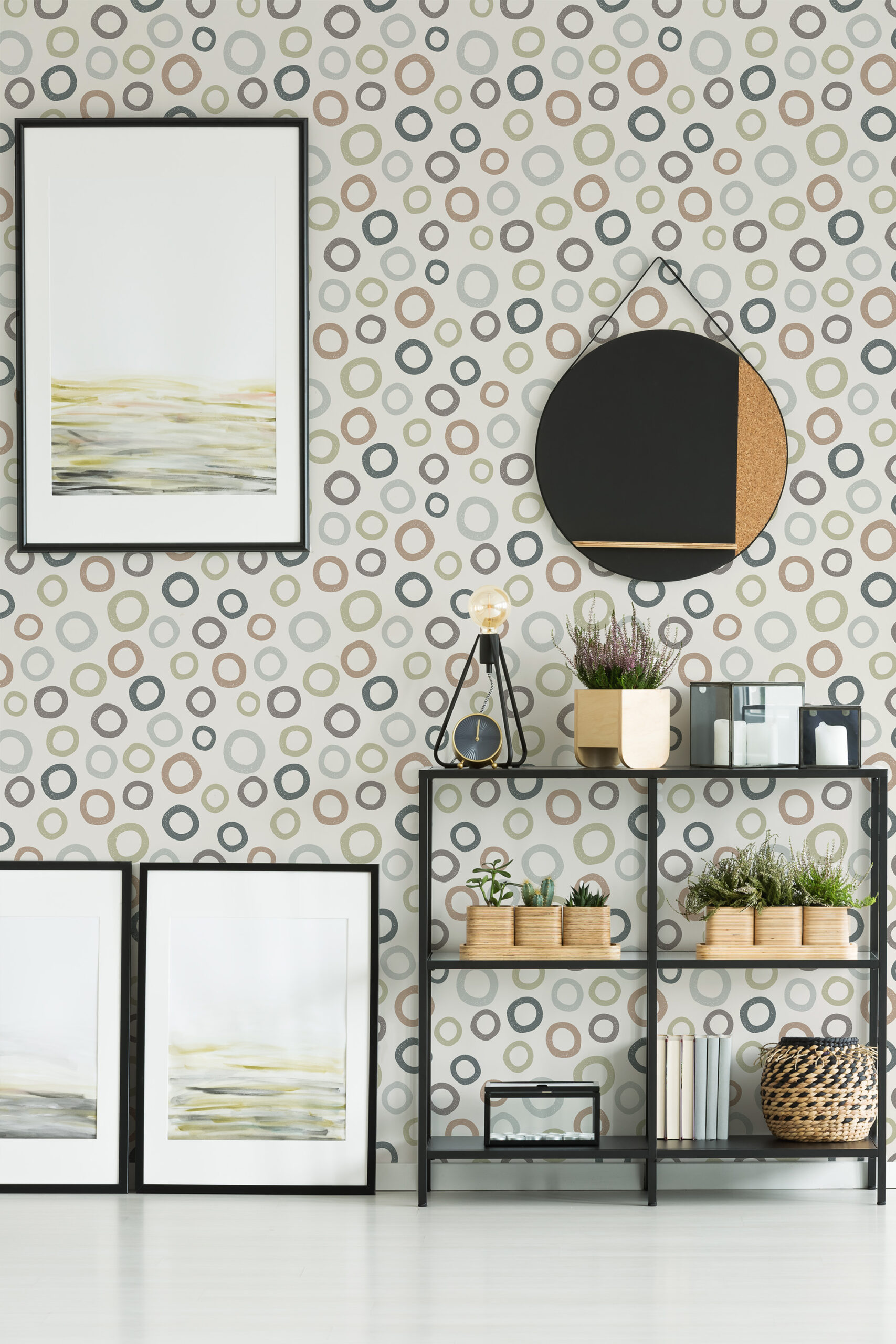Scattered Beige Ring Dots self-adhesive wallpaper with muted circles across a full wall behind framed art and a black shelf.