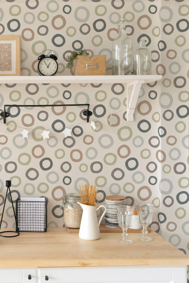 Scattered Beige Ring Dots peel and stick wallpaper with multicolor ring dots on a kitchen wall behind open shelves.