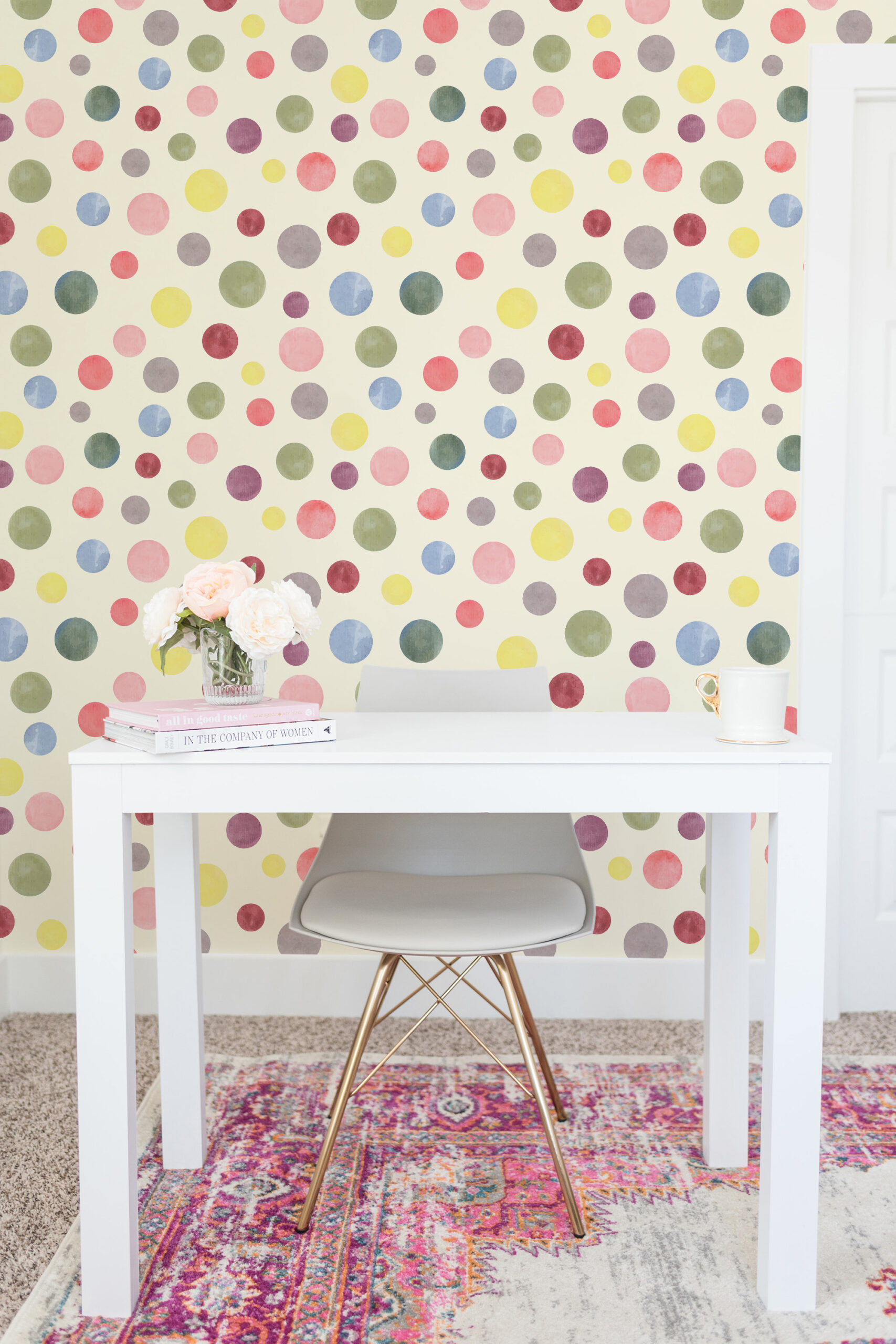 Watercolor Cream Polka Dot non-pasted wallpaper with pastel dots, shown as an accent wall behind a white desk.