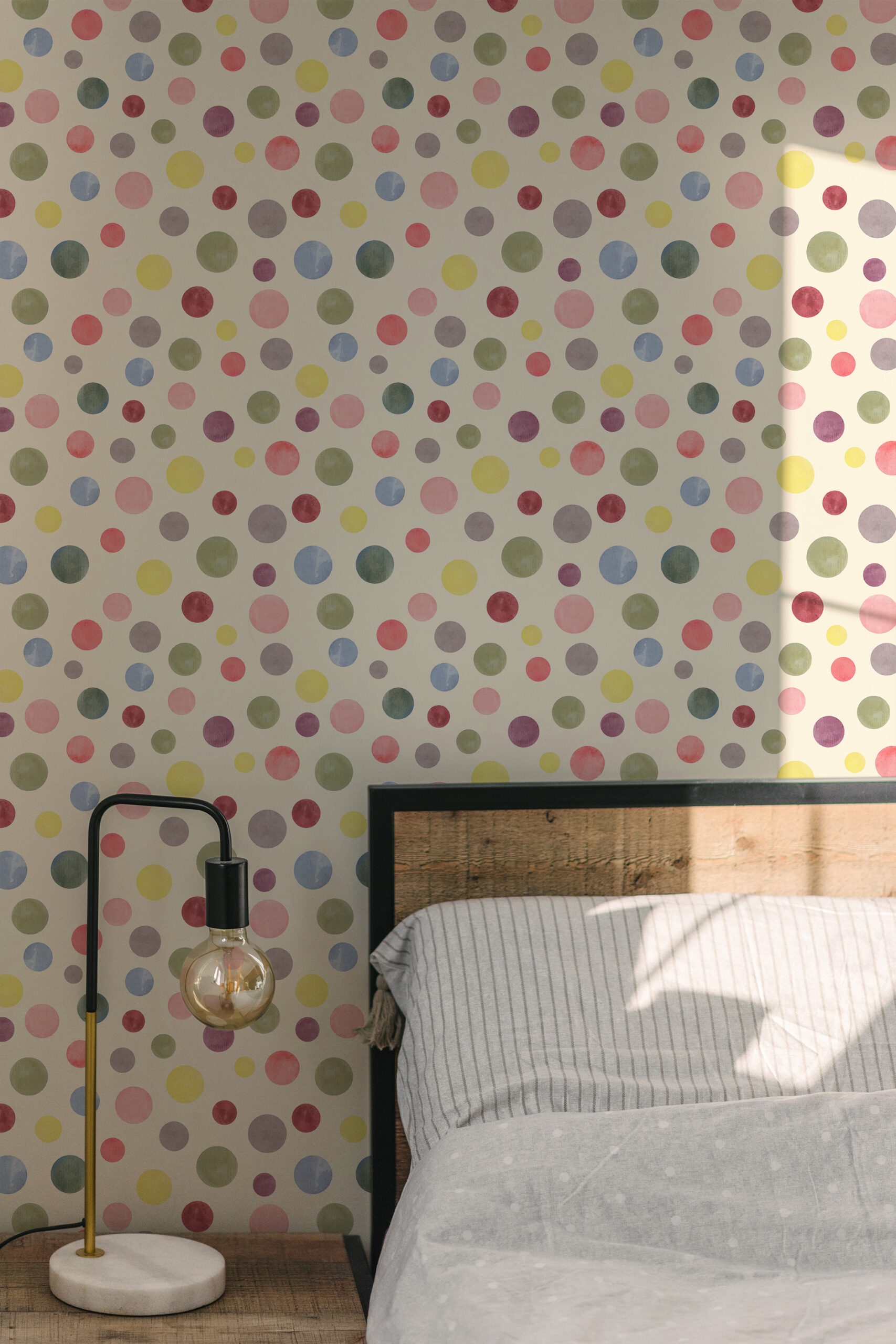 Watercolor Cream Polka Dot pre-pasted wallpaper with soft multicolor dots on a bedroom wall behind the bed.