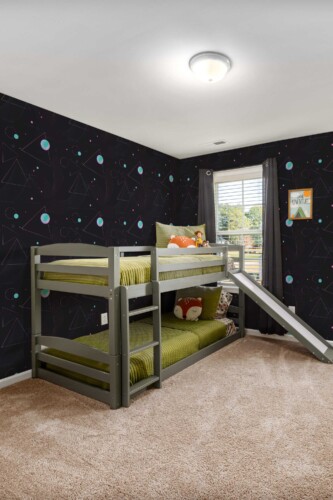 Cosmic Motives by Fancy Walls peel and stick wallpaper in black with glowing planets for bold teen bedrooms