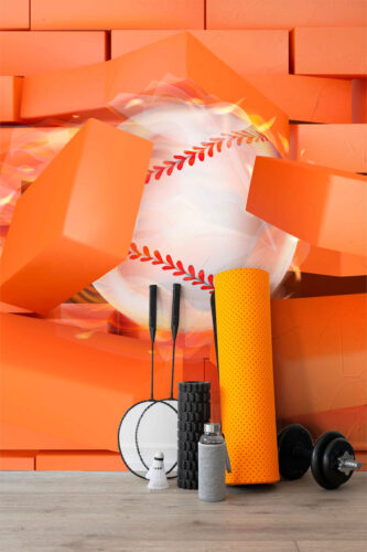 Baseball Breakthrough mural wallpaper shows a large baseball smashing through orange bricks with motion blur on a wall mural behind gym gear.