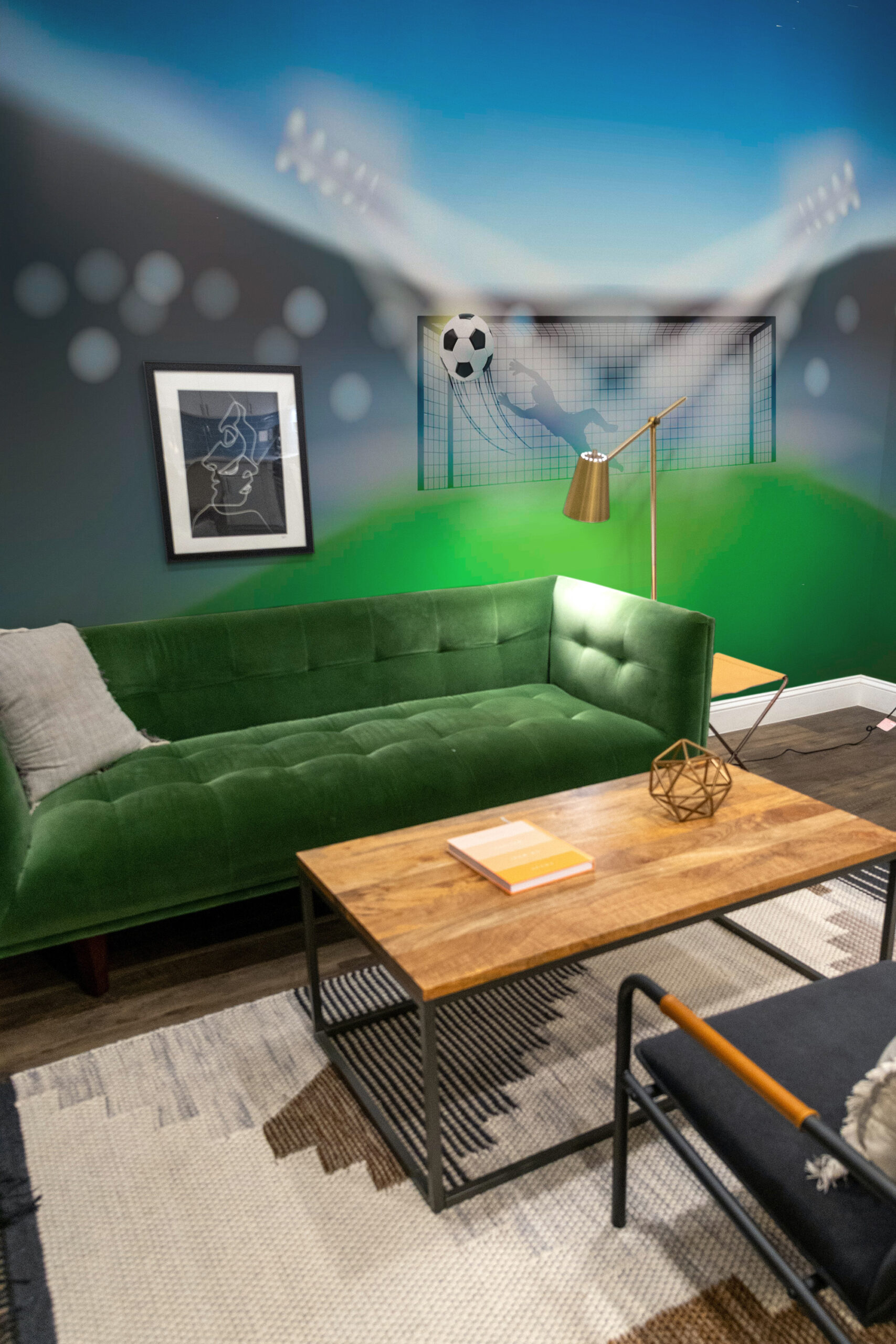 Dynamic Soccer Goal wall mural on a living room accent wall, showing a soccer ball flying into the net in a stadium scene.