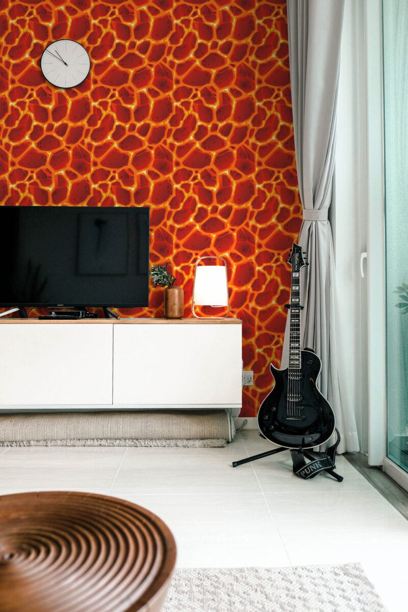 Bold Red Lava Cracks peel and stick wallpaper with a cracked lava pattern covering the wall behind a TV console.
