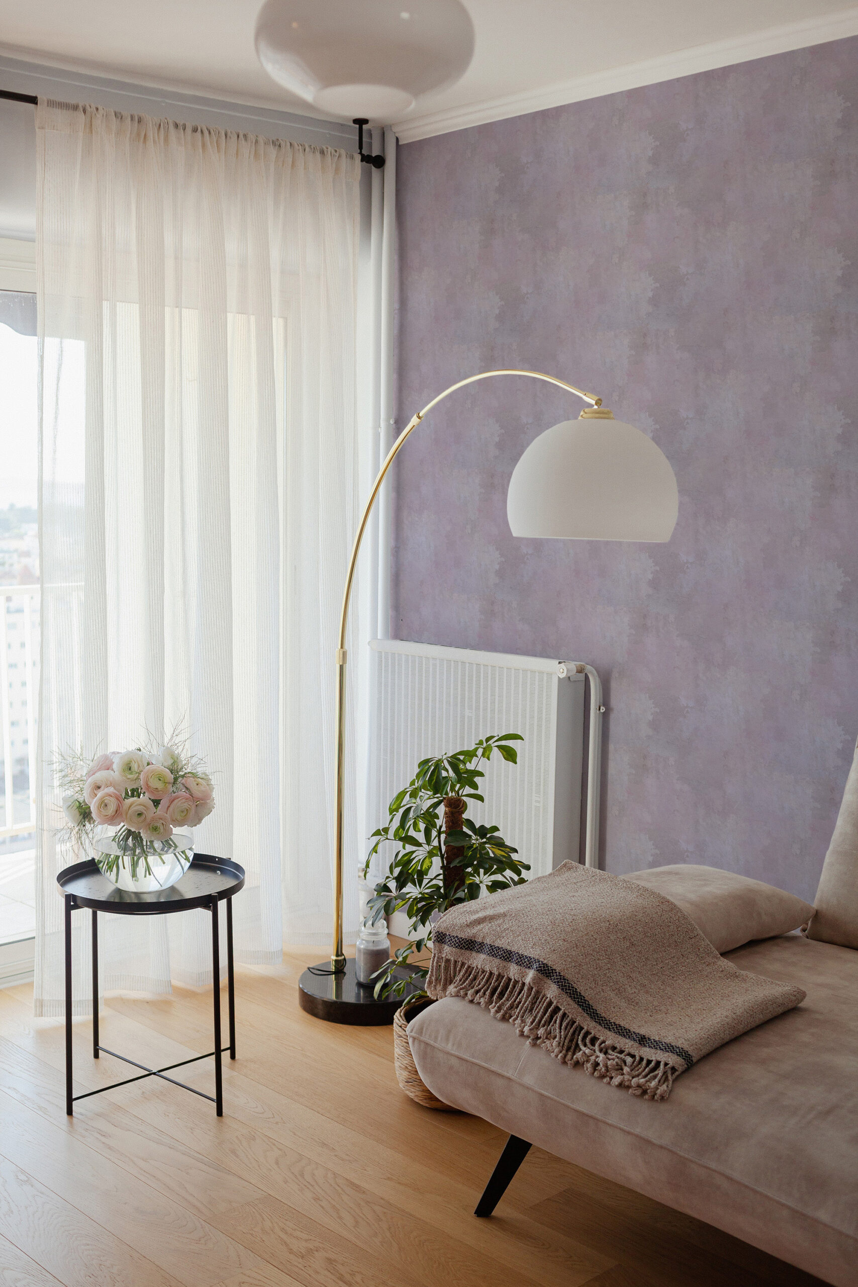 Cloudy Pink Plaster Look pre-pasted wallpaper on a bedroom accent wall behind a floor lamp and daybed.