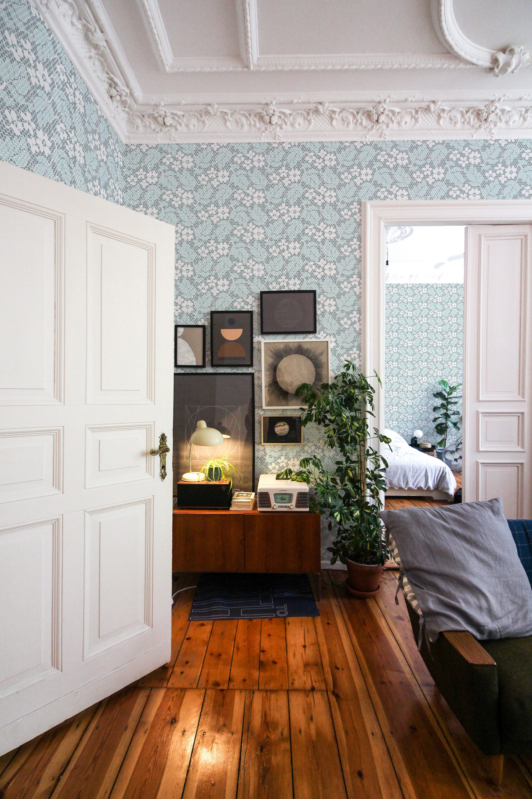 Fine Blue Lace Floral non-pasted wallpaper in a bedroom, with delicate blue lace-style florals on the main wall.