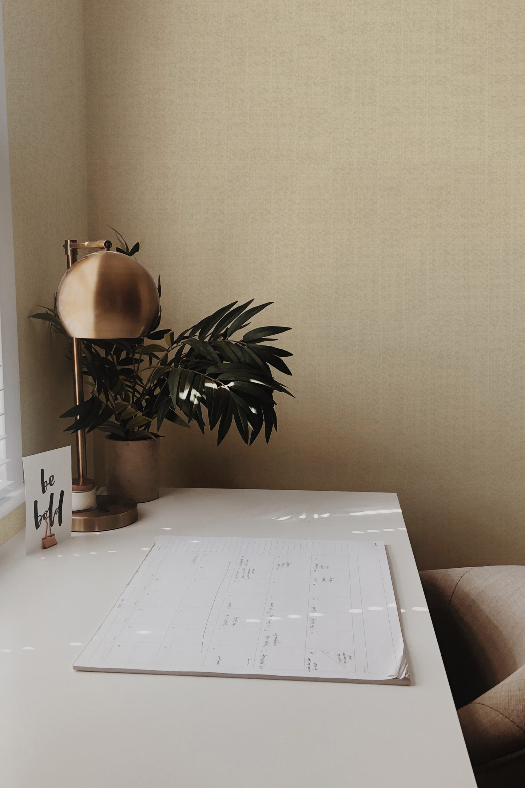 Fine Beige Fabric Look non-pasted wallpaper with a subtle woven texture, shown on a wall above a small desk.