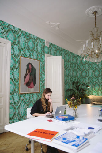 Dense Teal Snakeskin Look peel and stick wallpaper covers the office wall in a tight diamond snakeskin pattern.
