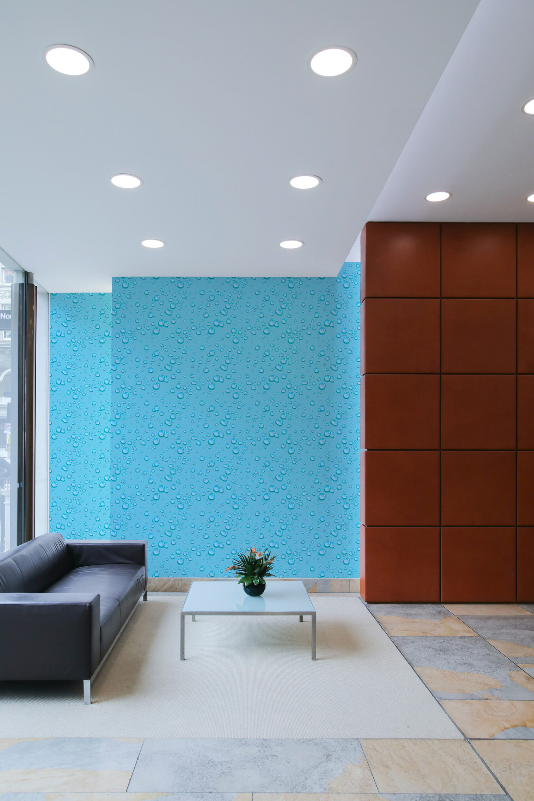 Dense Turquoise Raindrops pre-pasted wallpaper with a water droplet pattern on an accent wall in a modern lounge.