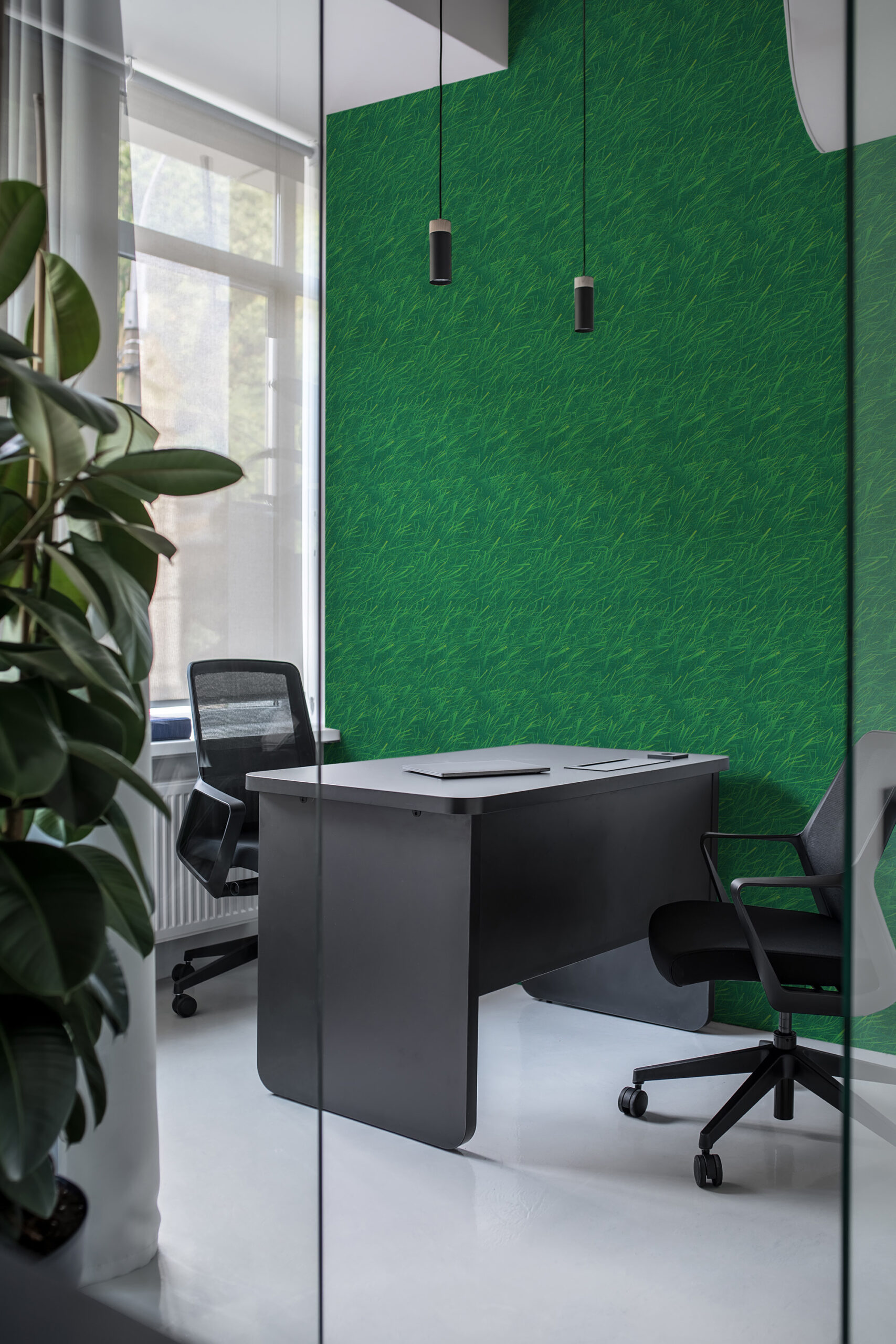 Dense Green Grass covers an office wall in self-adhesive wallpaper with a rich green lawn-like texture behind the desk.