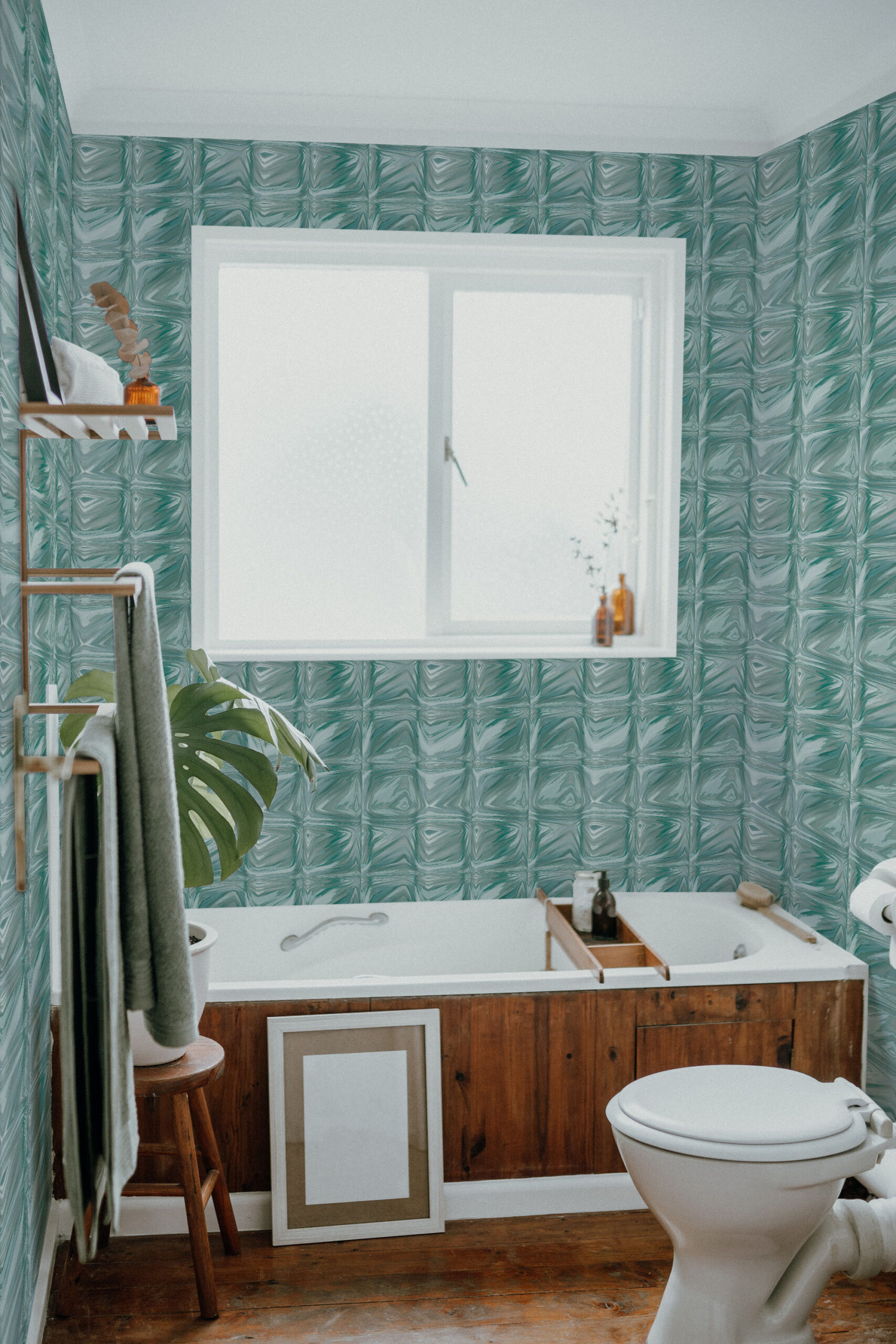 Teal Tile Look pre-pasted wallpaper in a bathroom, creating a glossy teal square-tile pattern around the window.